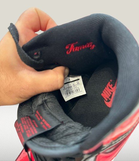 Close-up of the Wings logo on the heel of black-and-red Jordan 1 Patent-Bred sneakers