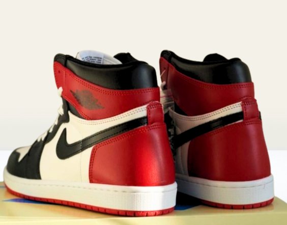 High heel view of Jordan 1 Black sneakers with red and black accent