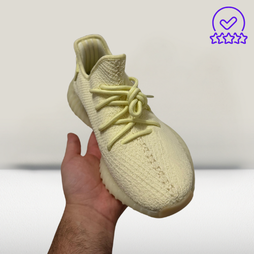 "Lifestyle shot of Yeezy 350 V2 Cream White sneakers styled with casual streetwear for maximum comfort