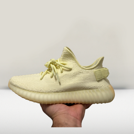 Side profile of Yeezy 350 V2 Cream White shoes showcasing Primeknit upper and BOOST midsole technology